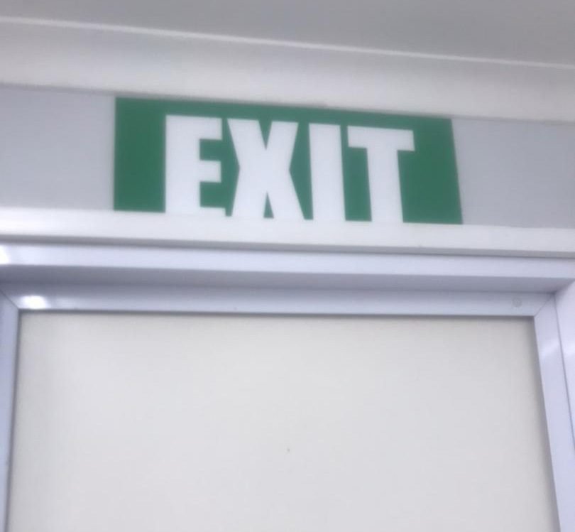 Green illuminated exit safety sign